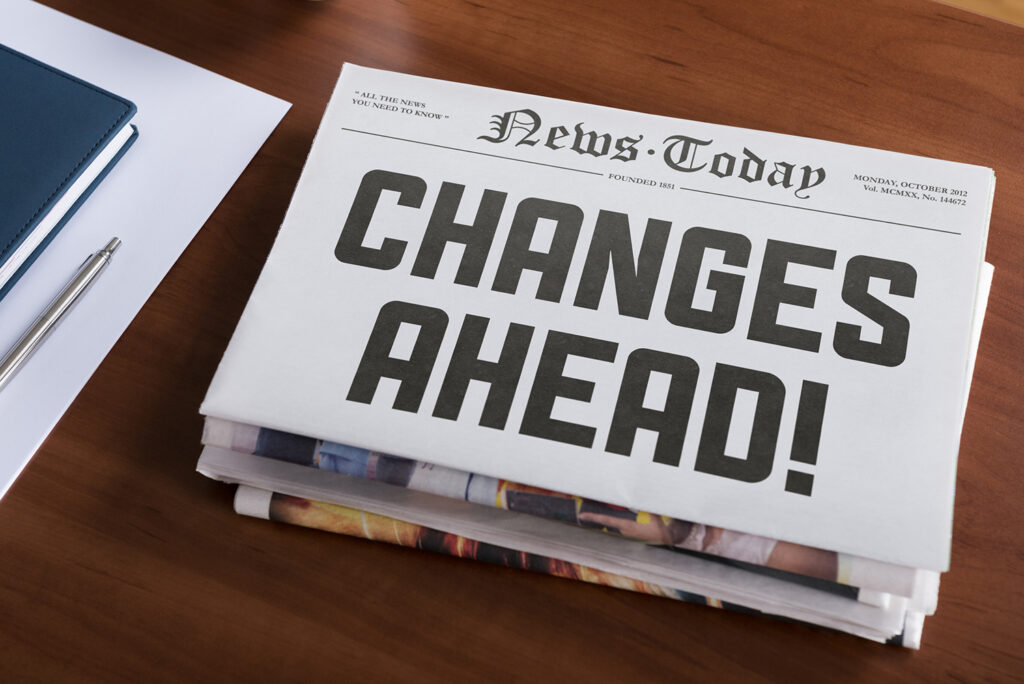 Newspaper sitting on a desk with the headline of "Changes Ahead!"